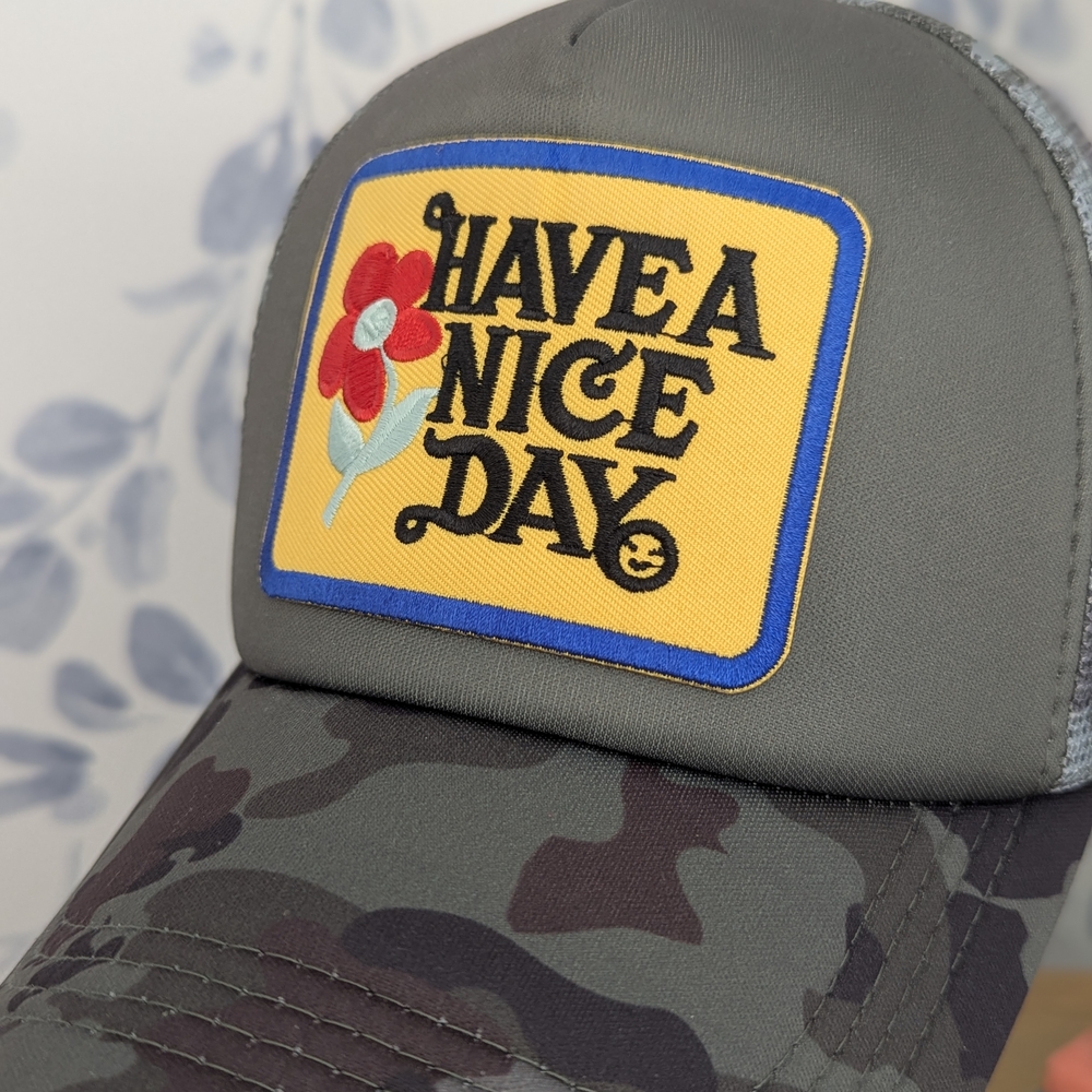 Camouflage Trucker hat with 'Have a Nice Day' Patch